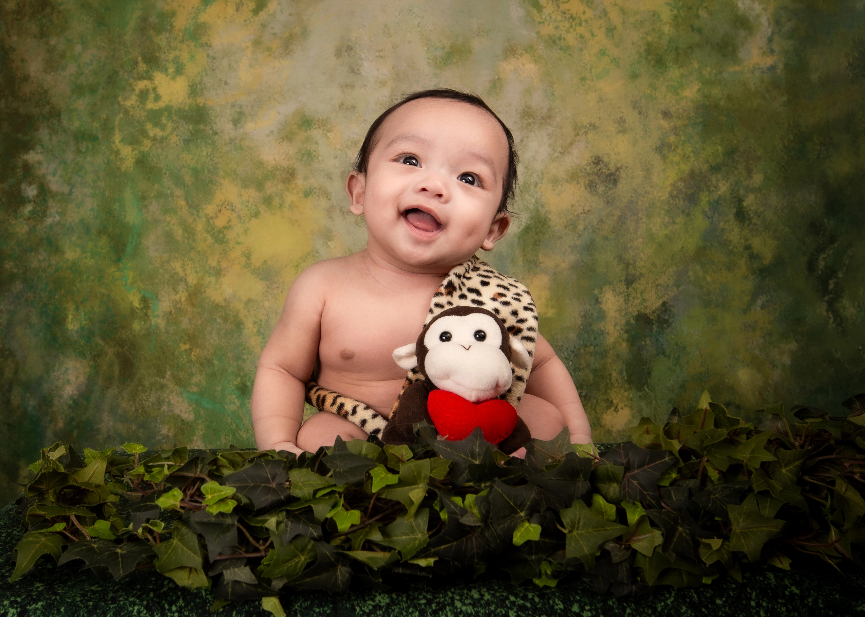 Newborn wrapped in neutral blanket during cozy Edmonton studio session