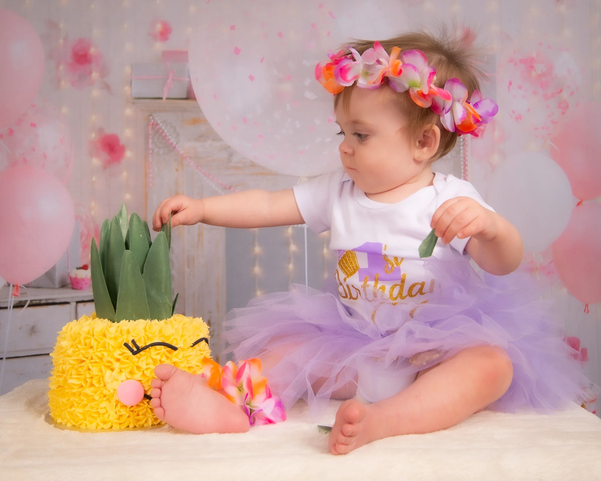 Smiling baby during milestone session on neutral studio backdrop
