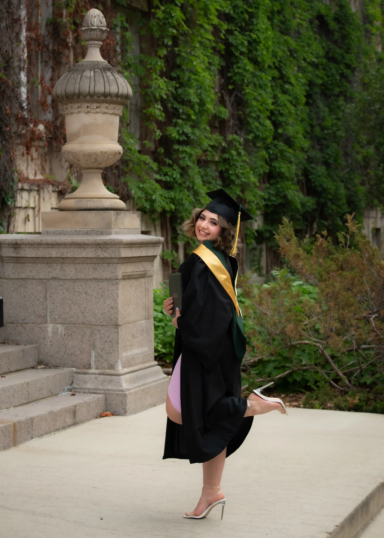 Graduate posing with a cap and gown